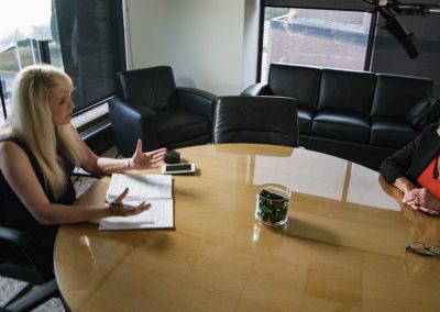Julie Staley interviewing Decatur Mayor Julie Moore Wolfe, sitting at conference table.