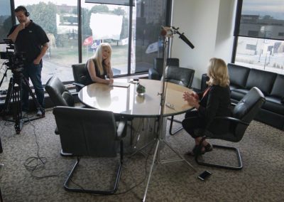 Julie Staley interviewing Decatur Mayor Julie Moore Wolfe, sitting at conference table.